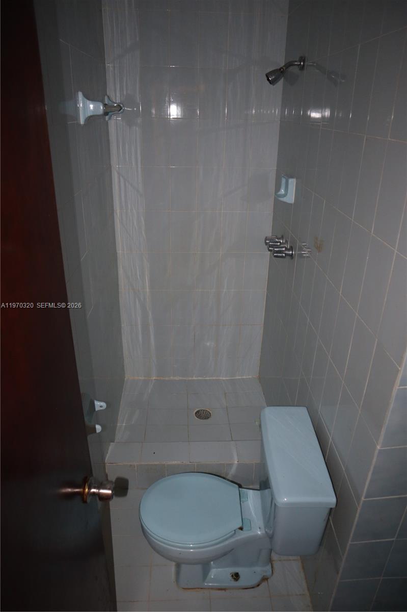 6514 Southwest 107th Place Miami, FL 33173 - Photo 16 of 18 a bathroom with a toilet and a shower