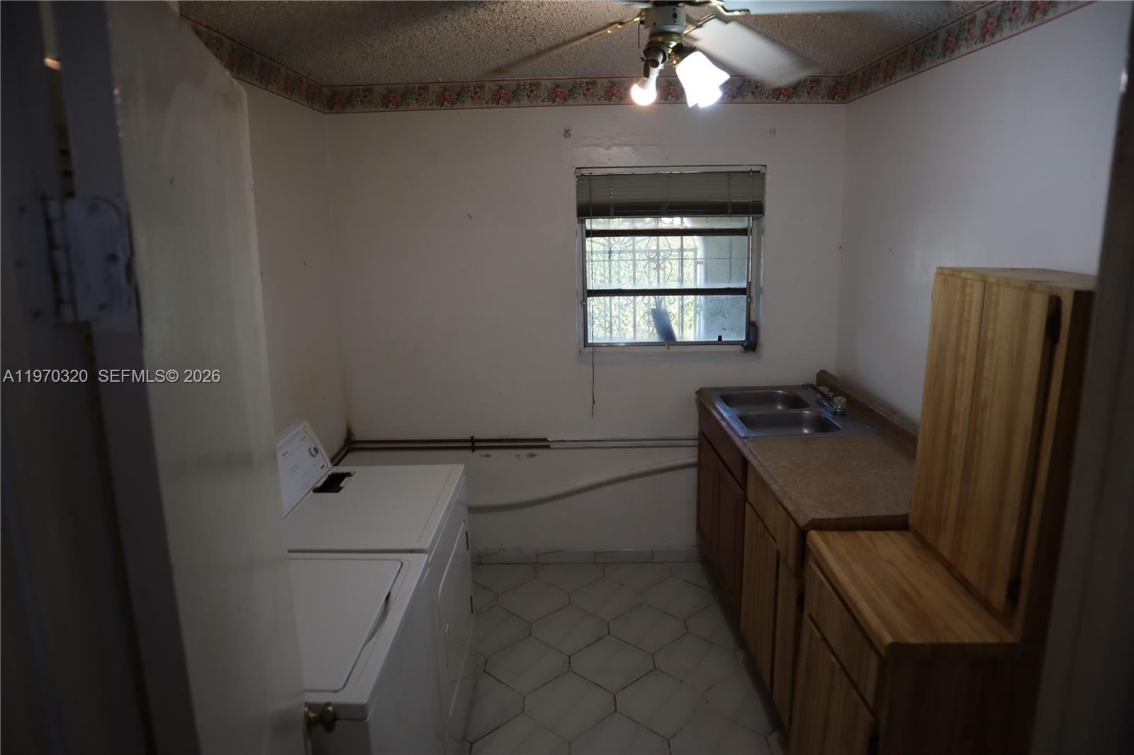 6514 Southwest 107th Place Miami, FL 33173 - Photo 9 of 18 a kitchen with a refrigerator and a stove top oven