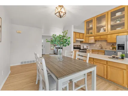 a kitchen with a table and chairs