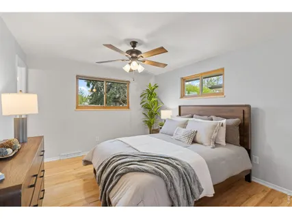 a bedroom with a bed chandelier and a window
