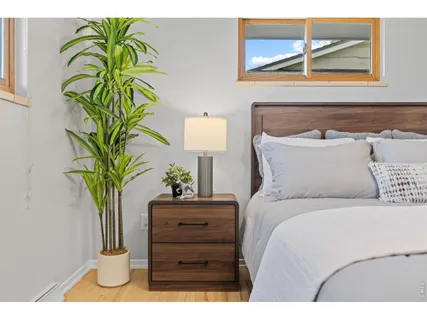 a bedroom with a bed and a potted plant