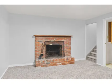 a living room with a fireplace and a ceiling fan