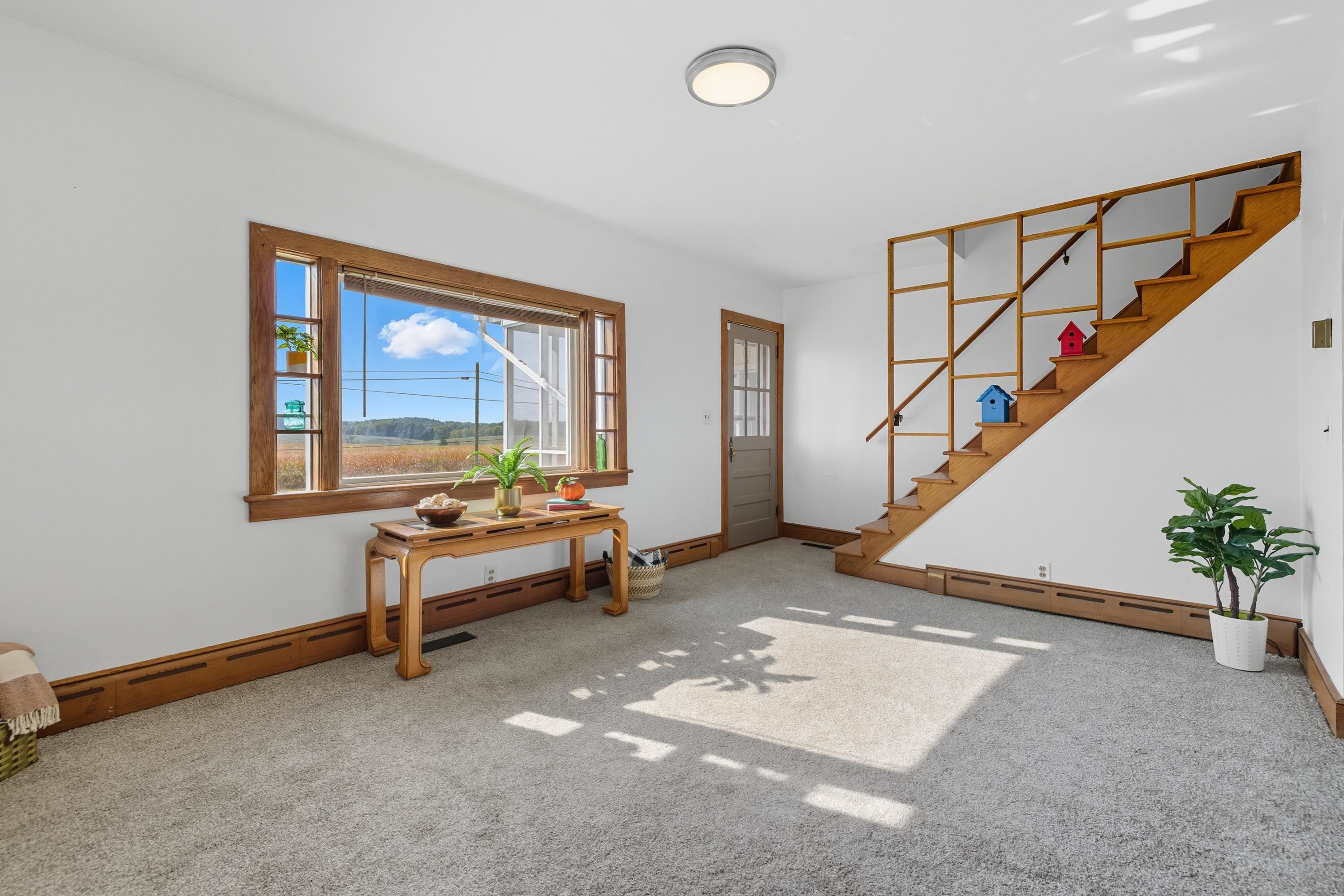 3138 Cross Keys Road Harrisonburg, VA 22801 - Photo 28 of 74 The living room space is located off the entrance to the home and near the steps leading to the upper level. This space features a fireplace, comfortable flooring, updated light fixture, and large windows allowing in an abundance of natural light!