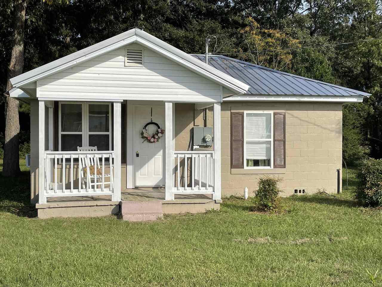 21 Peach Street Butler, GA 31006 - Photo 1 of 1 a front view of a house with a yard