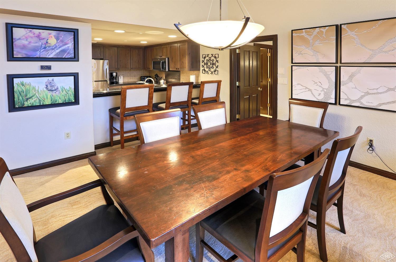 210 Offerson Road, Unit 209 WEEK 11 Beaver Creek, CO 81620 - Photo 5 of 37 a view of a dining room with furniture and a large window