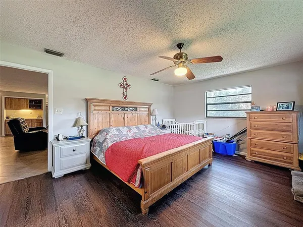 a spacious bedroom with a bed and a chandelier