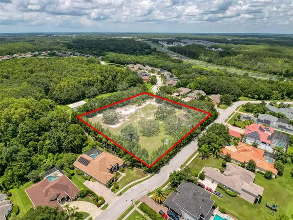 an aerial view of residential houses with outdoor space and seating