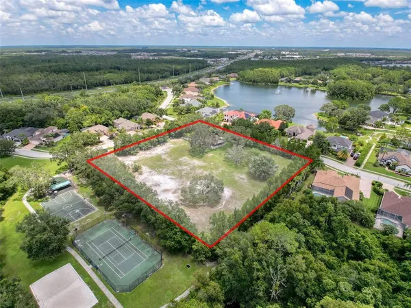 an aerial view of lake residential house with swimming pool and outdoor space