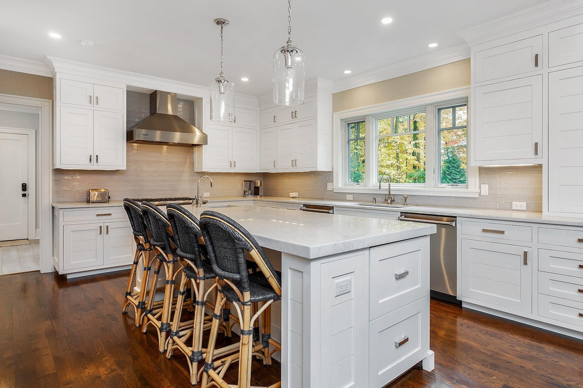 75 Parish Road New Canaan, CT 06840 - Photo 14 of 38 a kitchen that has a lot of cabinets in it with stainless steel appliances granite countertop a stove a sink a window and white cabinets