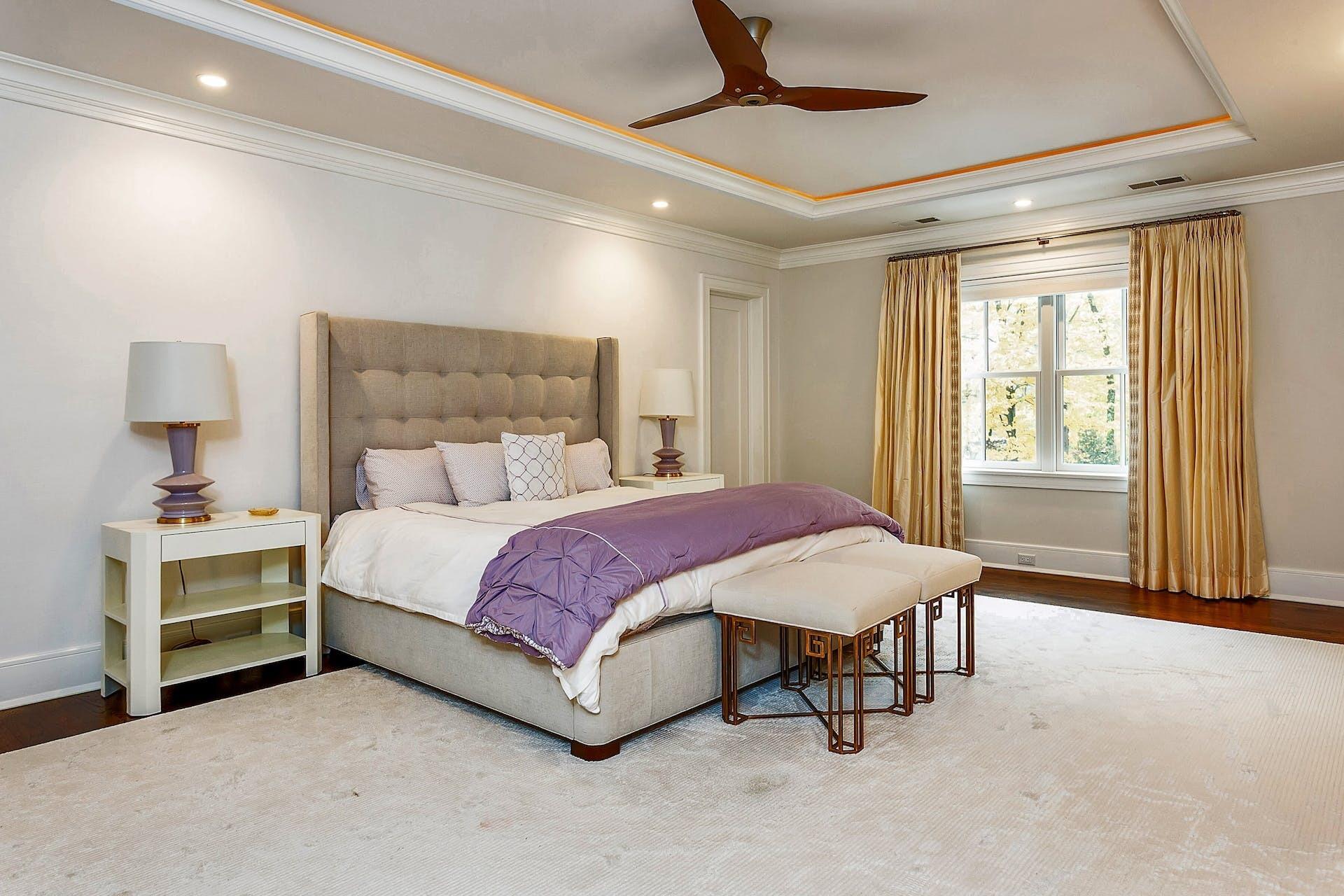 75 Parish Road New Canaan, CT 06840 - Photo 17 of 38 a spacious bedroom with a bed and a chandelier
