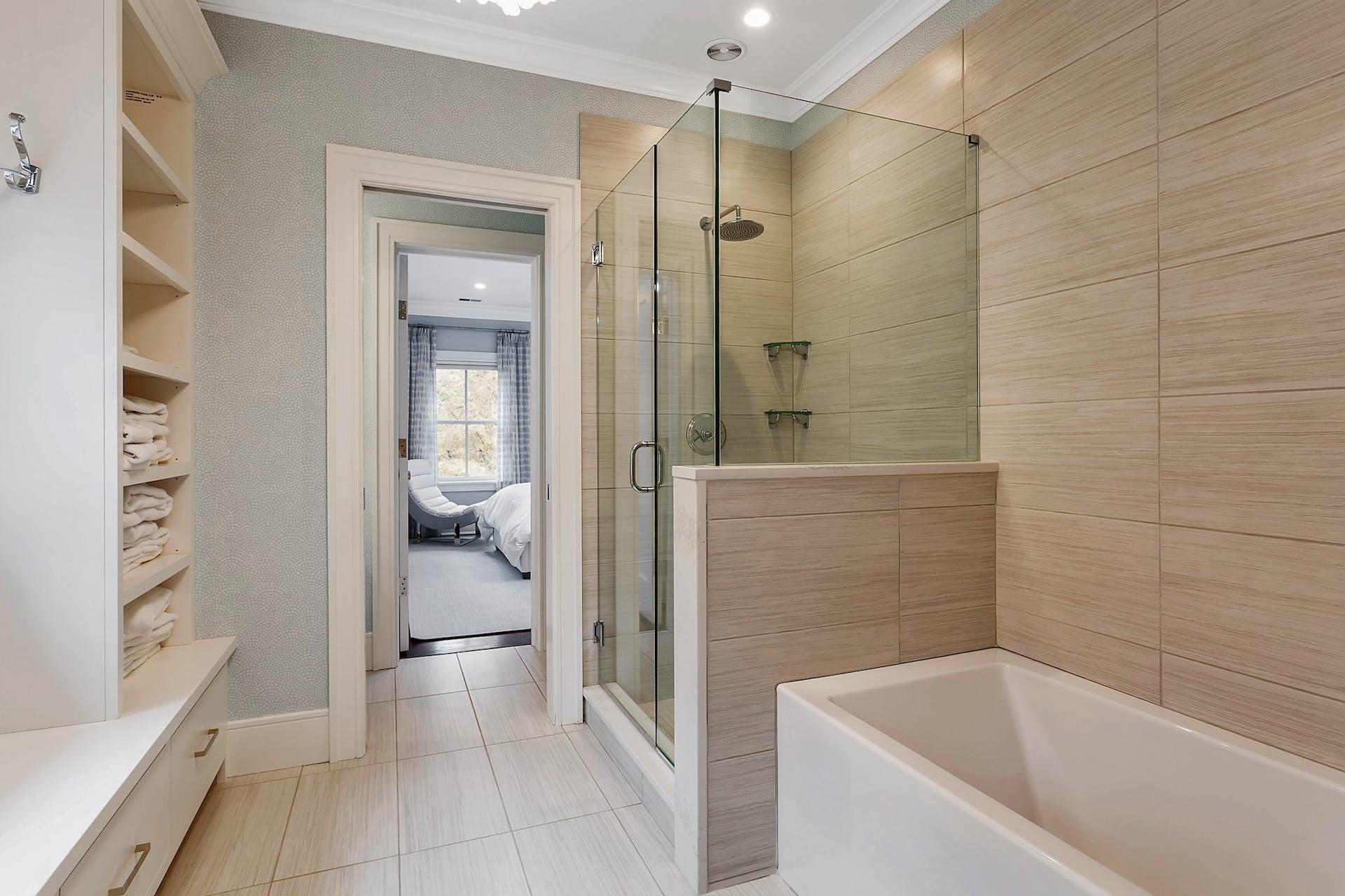 75 Parish Road New Canaan, CT 06840 - Photo 21 of 38 a bathroom with a bathtub and a shower