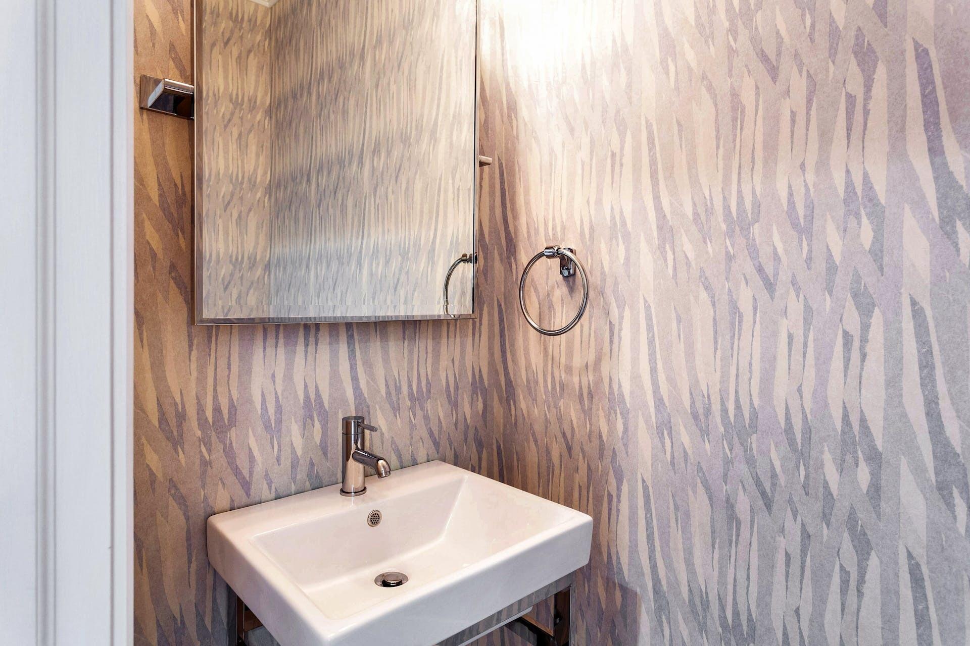 75 Parish Road New Canaan, CT 06840 - Photo 27 of 38 a bathroom with a sink and a mirror