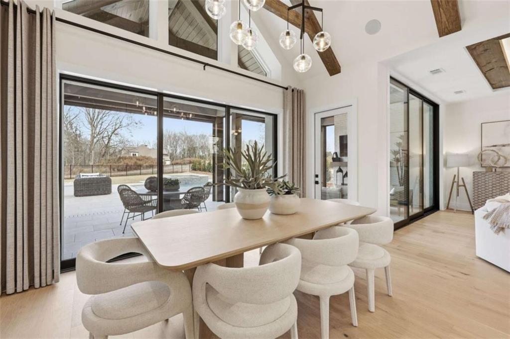 4632 A Shirley Road Gainesville, GA 30506 - Photo 18 of 72 a view of a dining room with furniture a chandelier and wooden floor