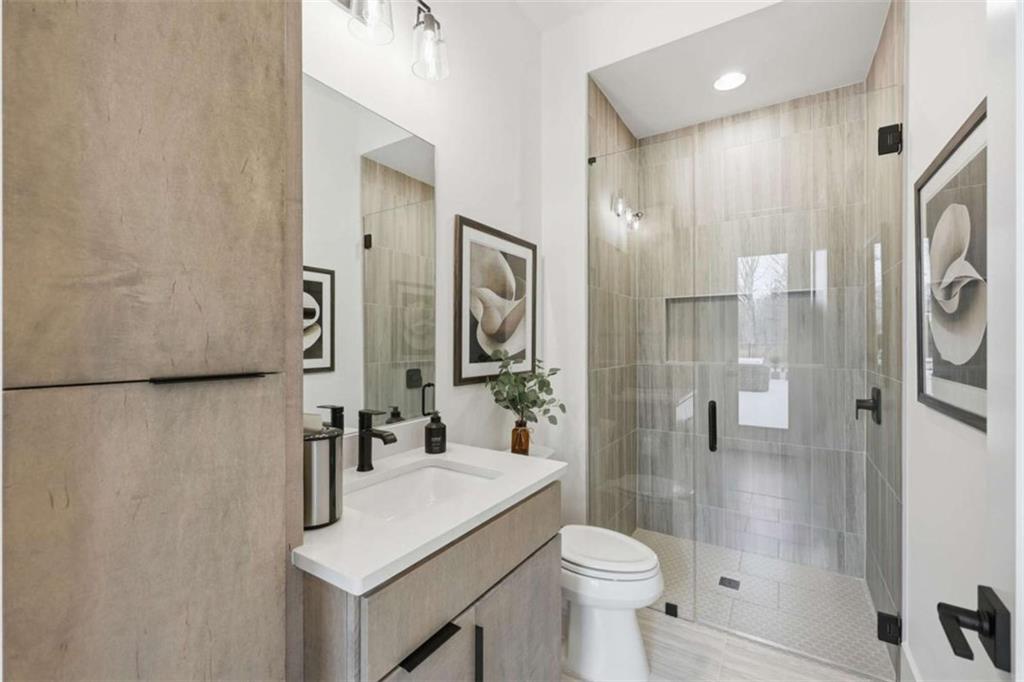 4632 A Shirley Road Gainesville, GA 30506 - Photo 33 of 72 a bathroom with a sink toilet a mirror and shower