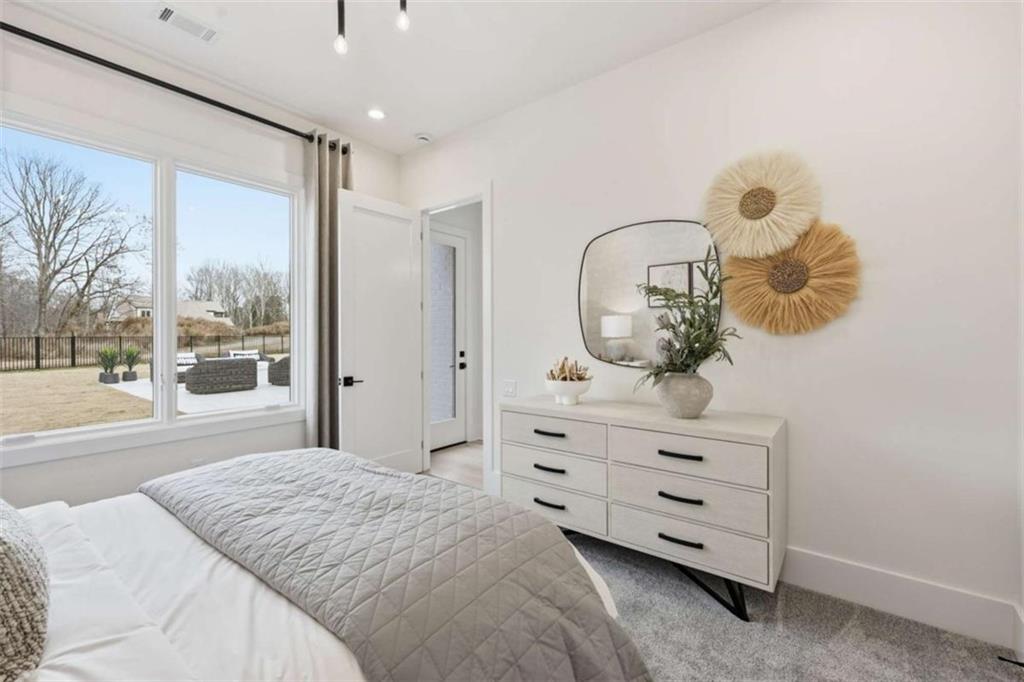 4632 A Shirley Road Gainesville, GA 30506 - Photo 35 of 72 a bedroom with a bed and a large window