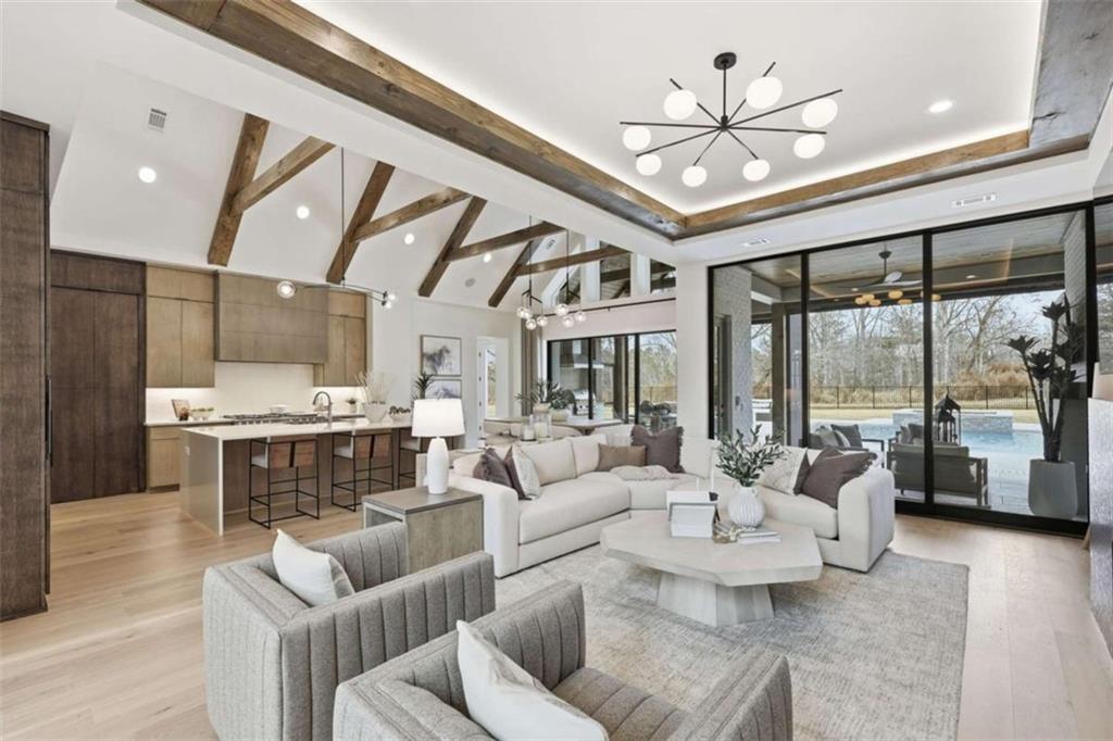 4632 A Shirley Road Gainesville, GA 30506 - Photo 10 of 72 a living room with furniture a large window and a chandelier