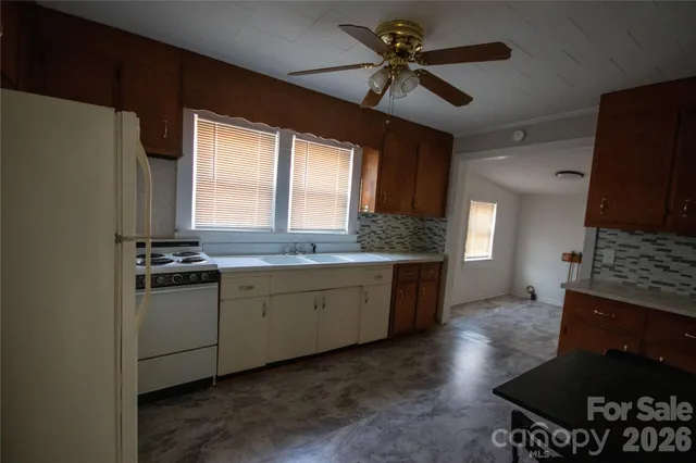 a kitchen with a sink stove and refrigerator