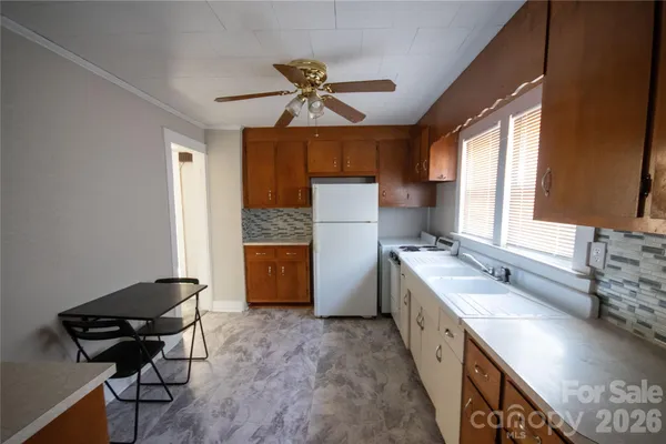 a kitchen with a sink appliances and a window