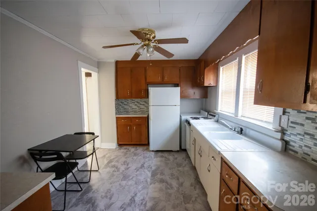 a kitchen with a sink appliances and a window