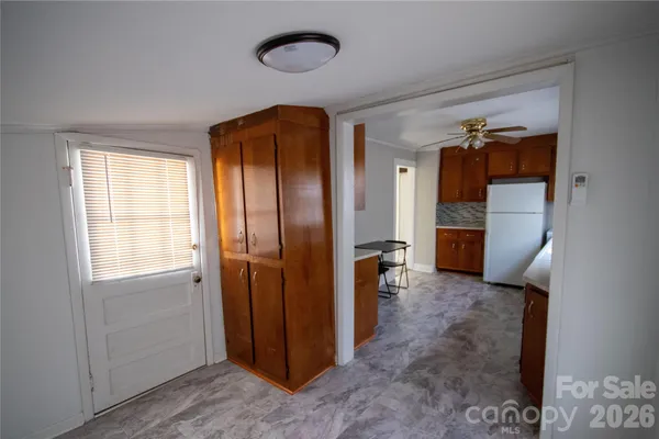 a view of a house with backyard and chairs