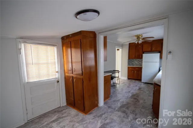 a view of a house with backyard and chairs