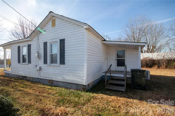 a view of a house with a wooden fence