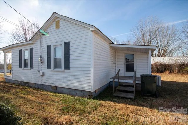 a view of a house with a wooden fence