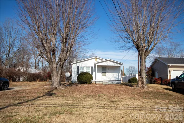 a front view of a house with a yard covered in snow