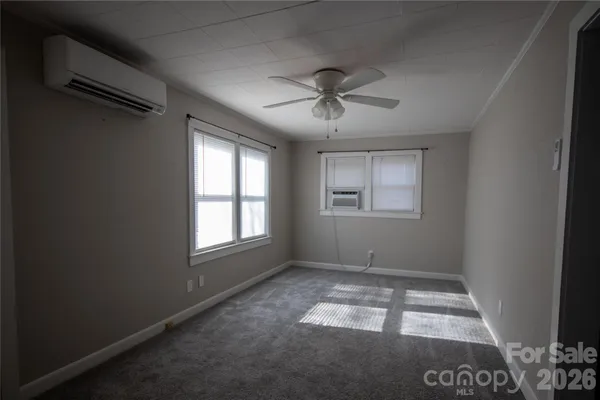 a view of room with window and ceiling fan