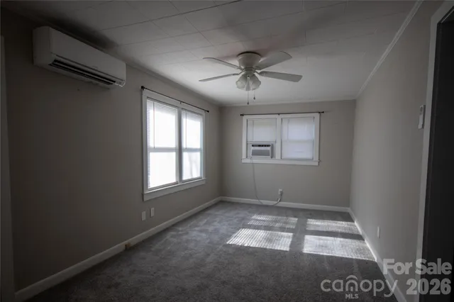 a view of room with window and ceiling fan