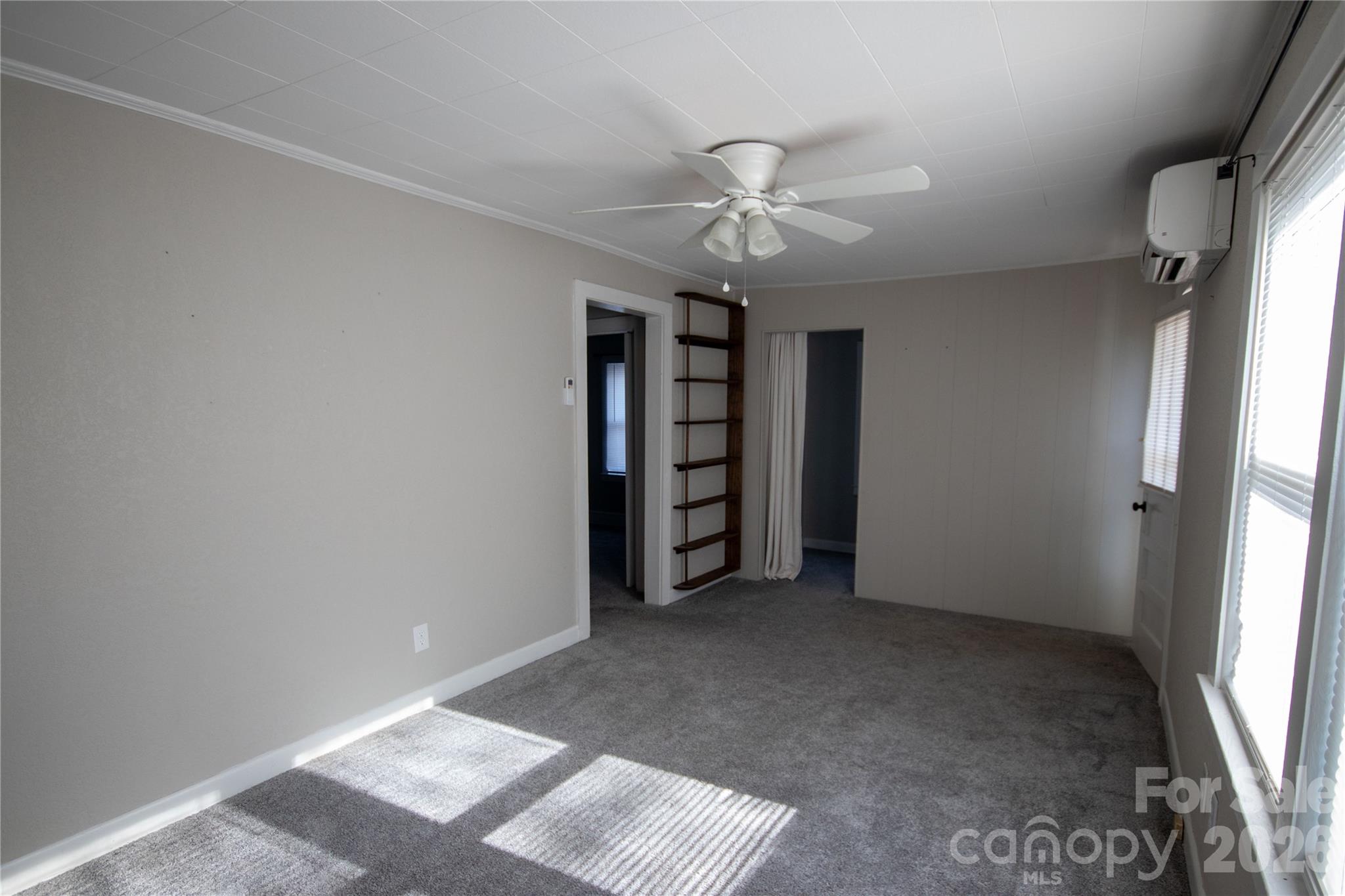 231 Cedar Valley Road Hudson, NC 28638 - Photo 9 of 33 an empty room with a ceiling fan and window