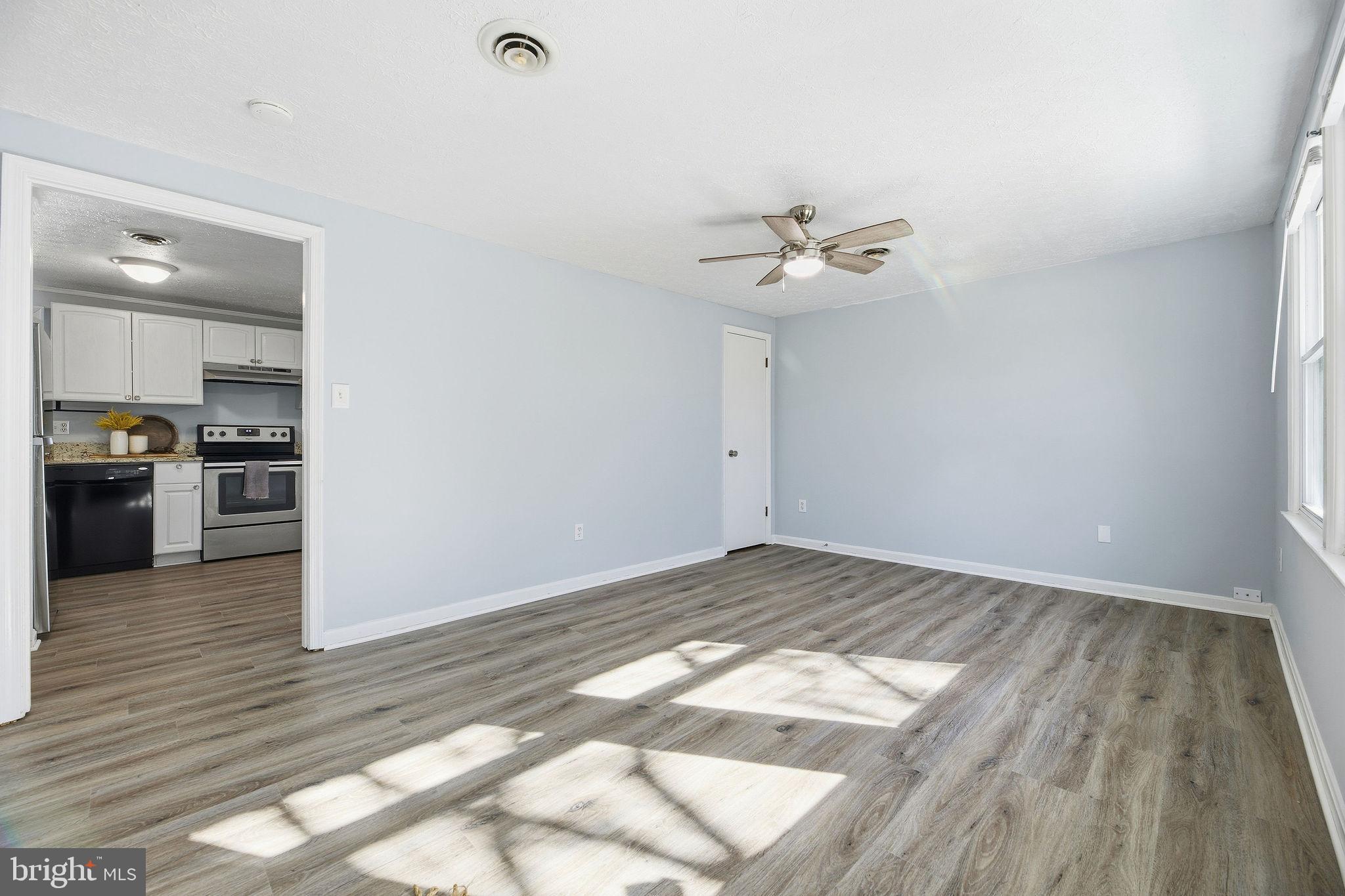 13108 Joy Road Lusby, MD 20657 - Photo 12 of 40 a view of a kitchen with wooden floor and a ceiling fan