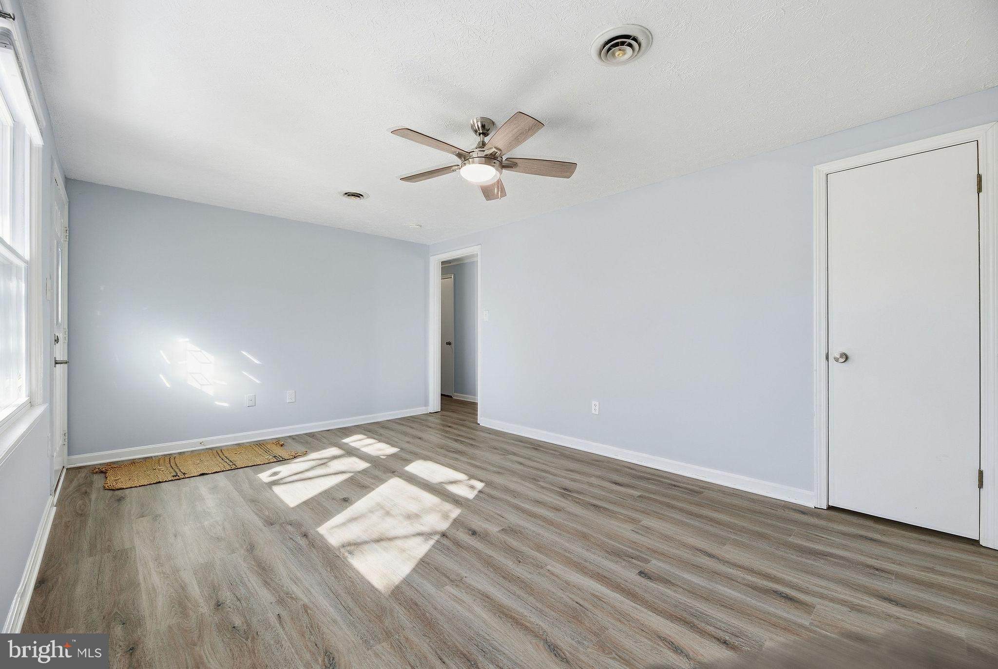 13108 Joy Road Lusby, MD 20657 - Photo 13 of 40 a view of empty room with wooden floor and fan