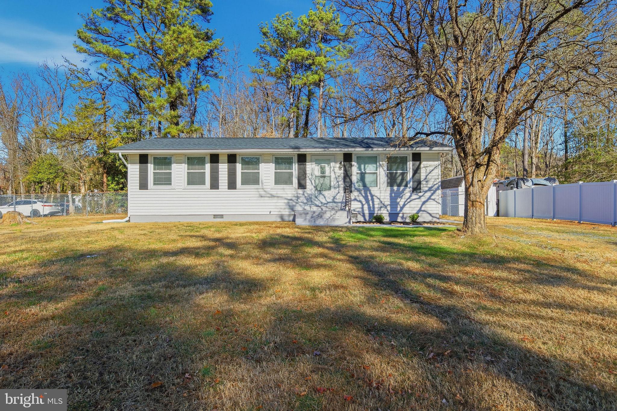 13108 Joy Road Lusby, MD 20657 - Photo 38 of 40 a view of a house with a big yard and large trees