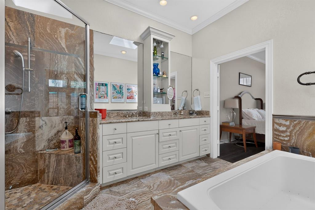 1526 Abrams Road Dallas, TX 75214 - Photo 19 of 38 Glass-enclosed shower with stone-tiled walls and built-in bench