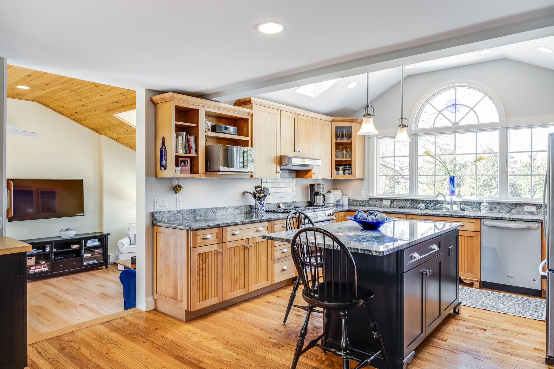 30 Beach Road Orleans, MA 02653 - Photo 5 of 76 a kitchen with stainless steel appliances granite countertop wooden cabinets a dining table and chairs