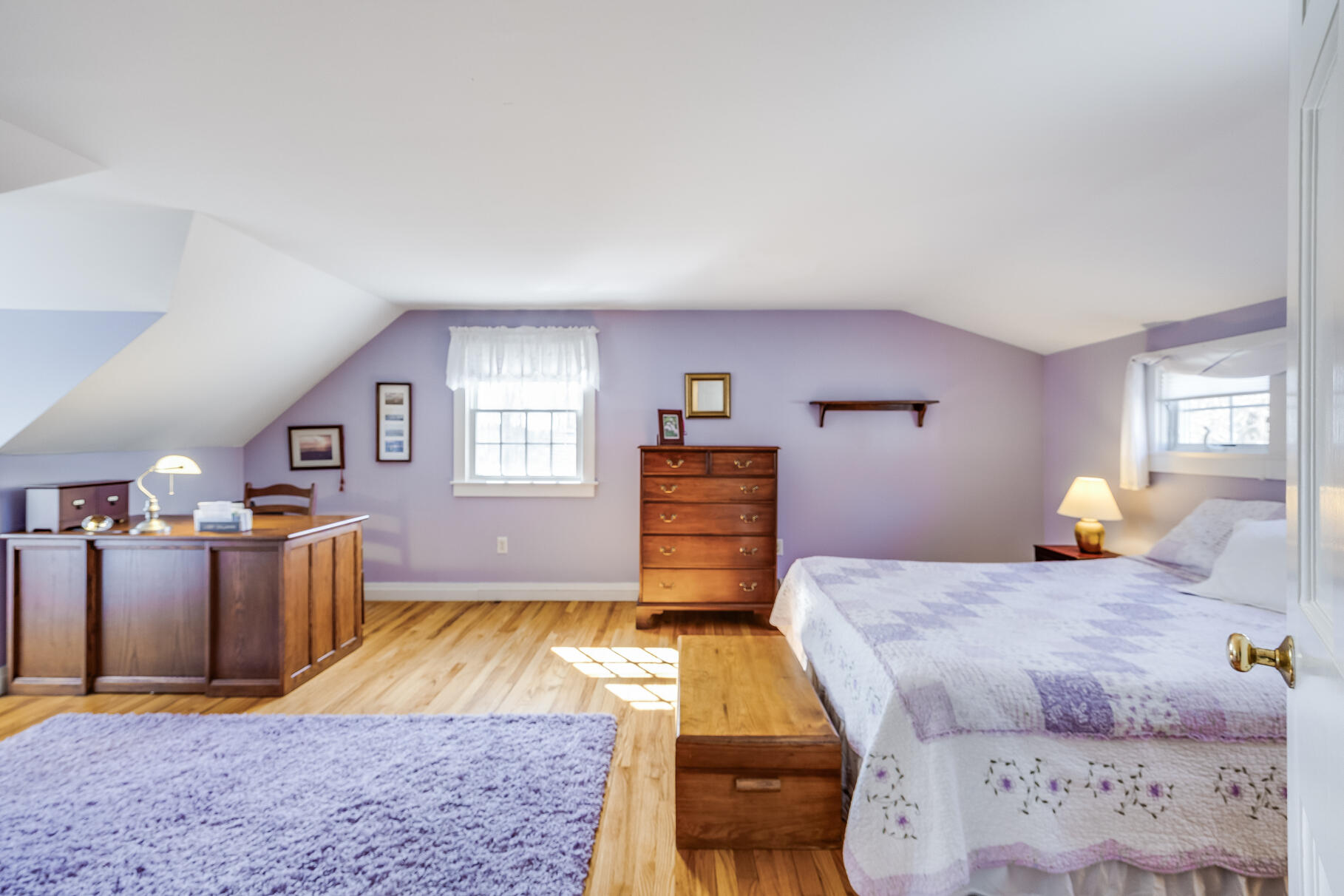 30 Beach Road Orleans, MA 02653 - Photo 52 of 76 a bedroom with a bed and wooden floor
