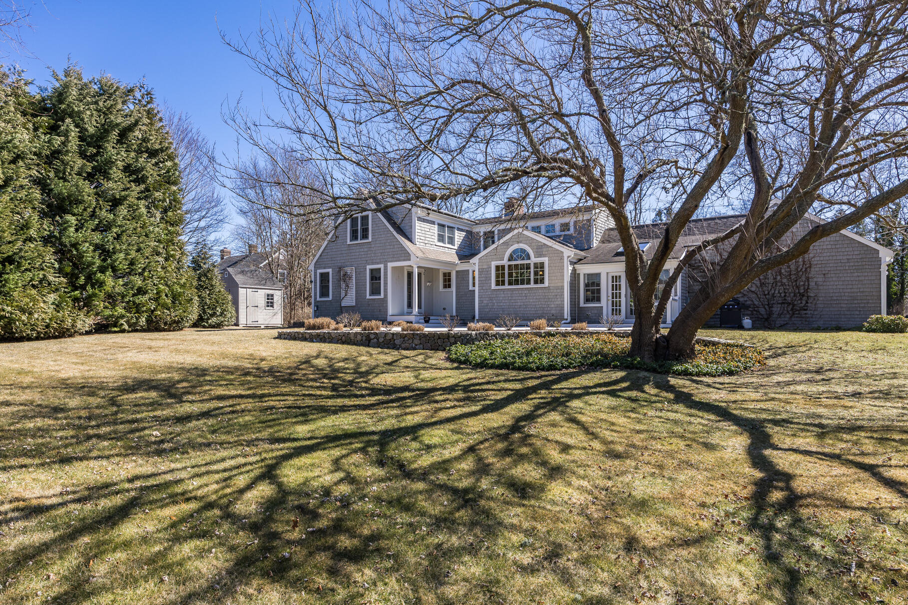 30 Beach Road Orleans, MA 02653 - Photo 61 of 76 a view of large house with a large tree next to a yard