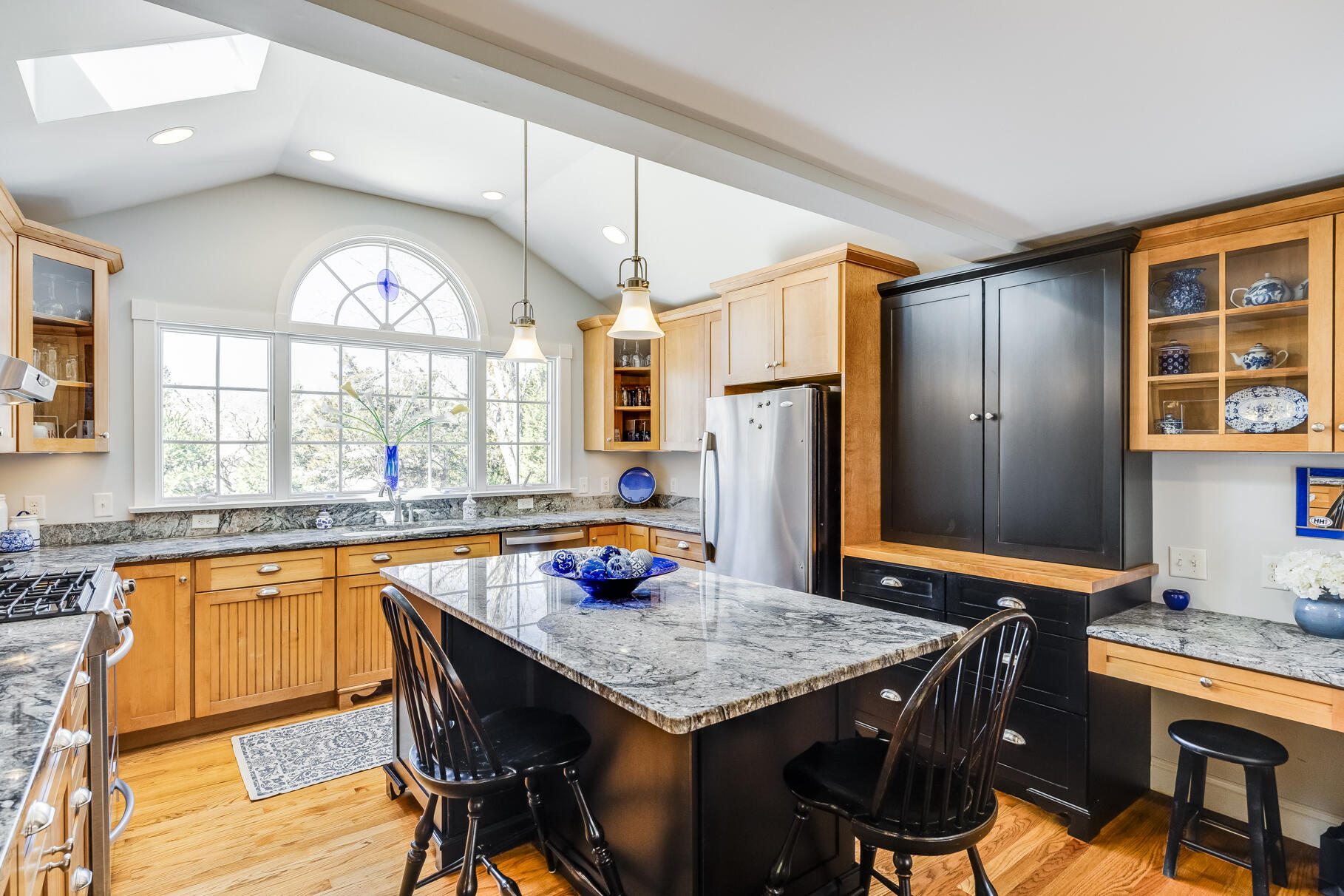 30 Beach Road Orleans, MA 02653 - Photo 7 of 76 a kitchen with stainless steel appliances granite countertop a stove a refrigerator a kitchen island a table and chairs in it