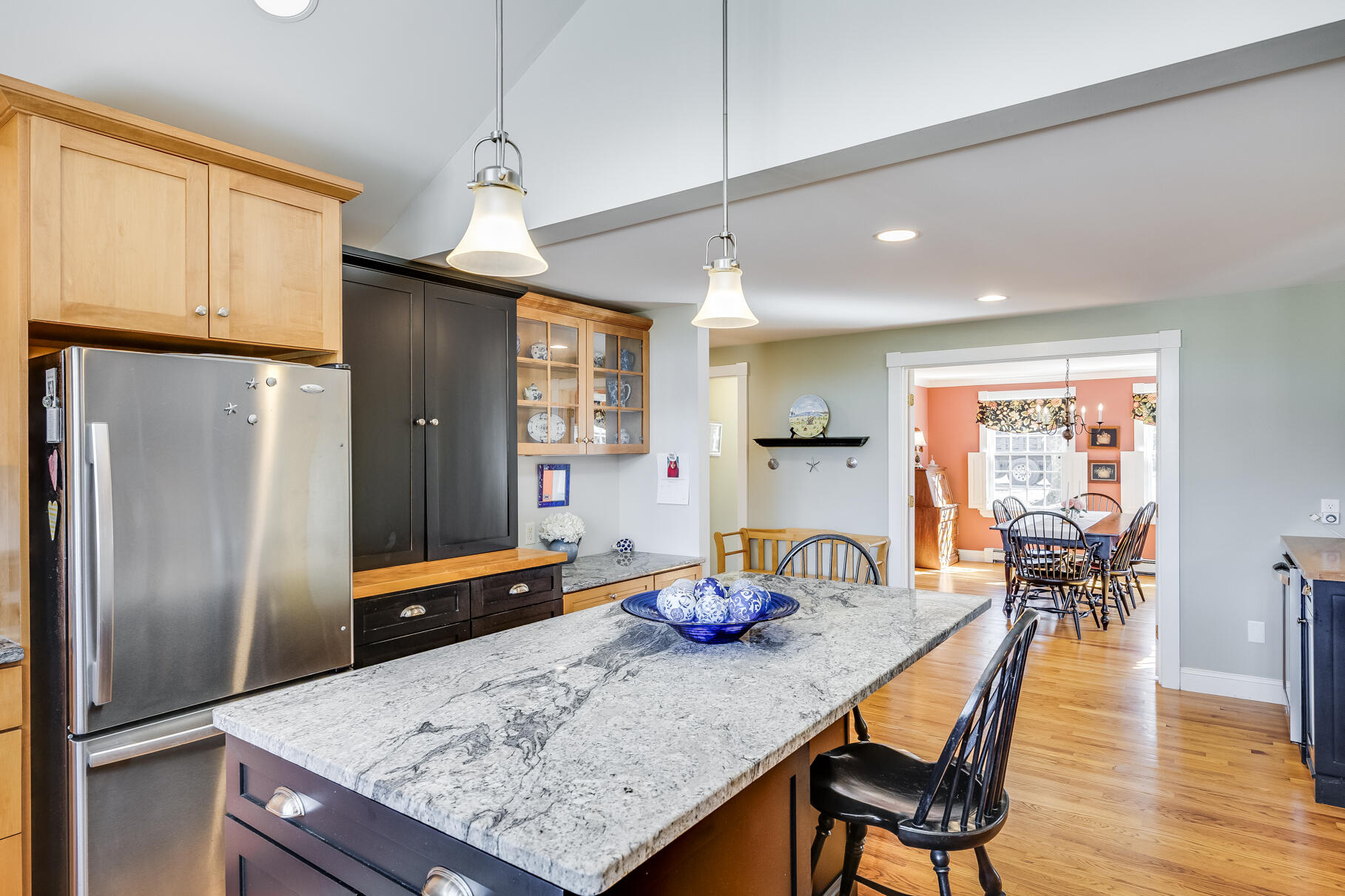 30 Beach Road Orleans, MA 02653 - Photo 9 of 76 a kitchen with stainless steel appliances granite countertop a kitchen island a table and chairs in it