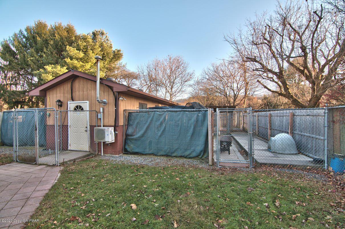 526 Weir Mountain Road Gilbert, PA 18331 - Photo 105 of 127 a view of a backyard with a plants and a large tree