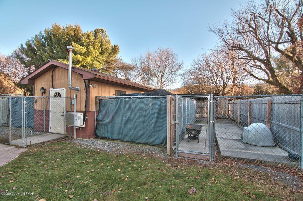 526 Weir Mountain Road Gilbert, PA 18331 - Photo 106 of 127 a backyard of a house with table and chairs