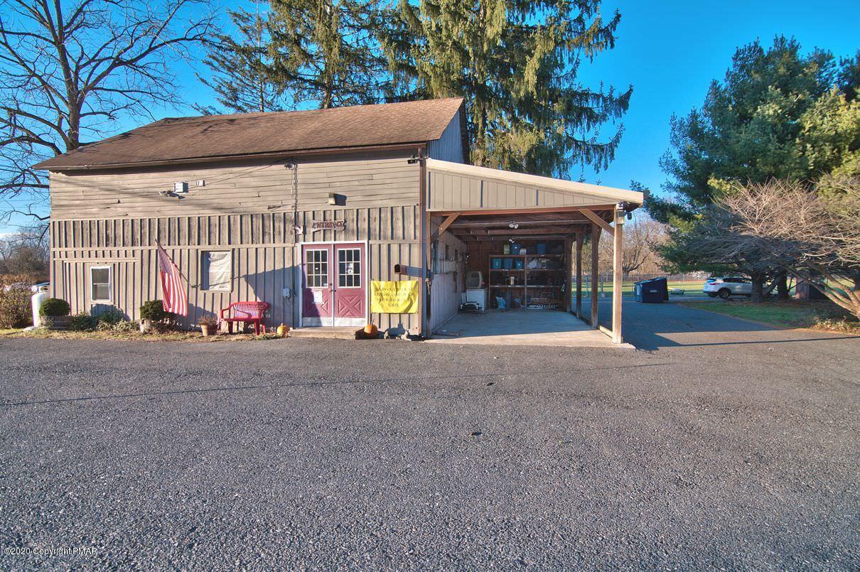 526 Weir Mountain Road Gilbert, PA 18331 - Photo 125 of 127 a view of a house with a yard and garage