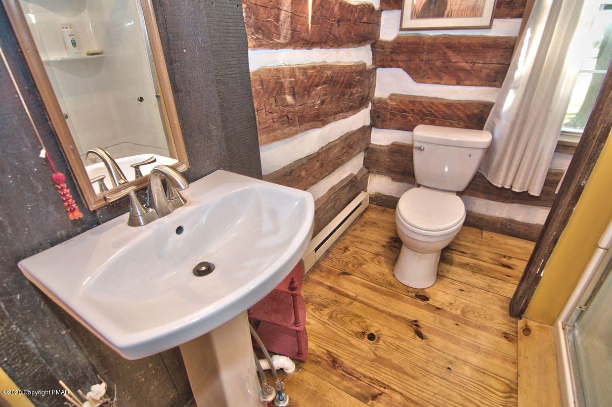 526 Weir Mountain Road Gilbert, PA 18331 - Photo 22 of 127 a bathroom with a sink a toilet and a mirror