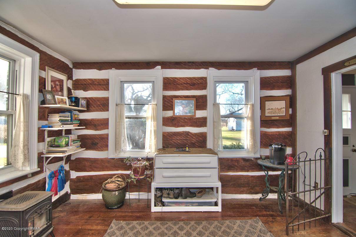 526 Weir Mountain Road Gilbert, PA 18331 - Photo 27 of 127 a living room with furniture a window and a book shelf