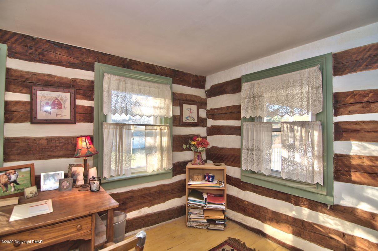 526 Weir Mountain Road Gilbert, PA 18331 - Photo 53 of 127 a living room with furniture and a floor to ceiling window