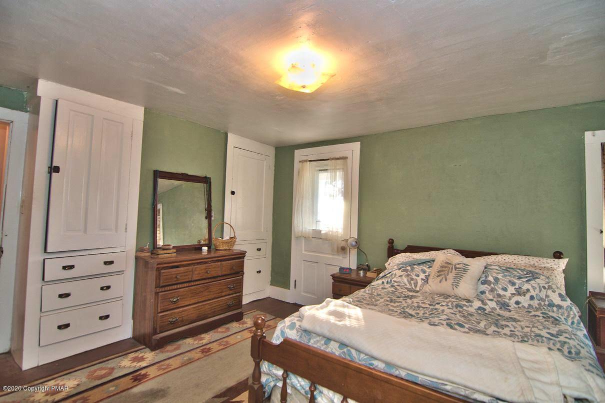 526 Weir Mountain Road Gilbert, PA 18331 - Photo 57 of 127 a bedroom with a bed and a dresser