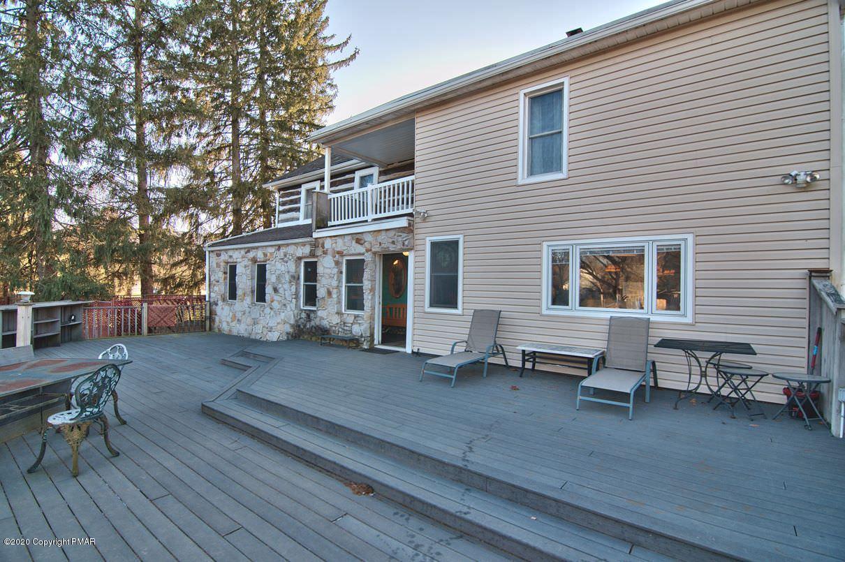 526 Weir Mountain Road Gilbert, PA 18331 - Photo 72 of 127 a view of a house with wooden deck and sitting area