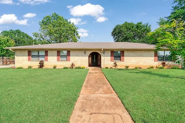 a front view of house with yard and green space