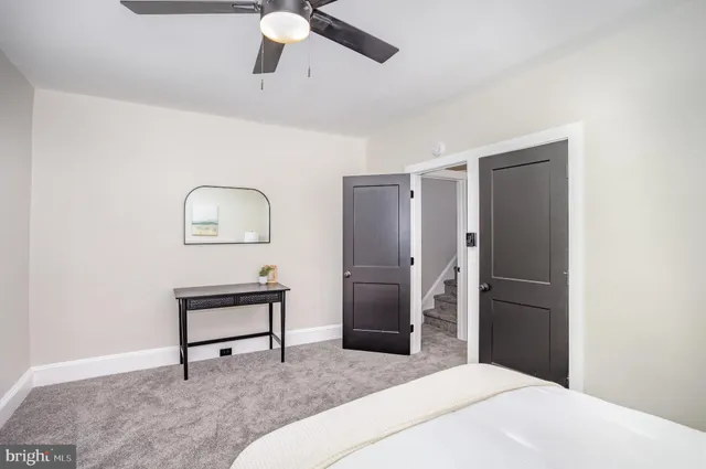 an empty room with a ceiling fan and a window